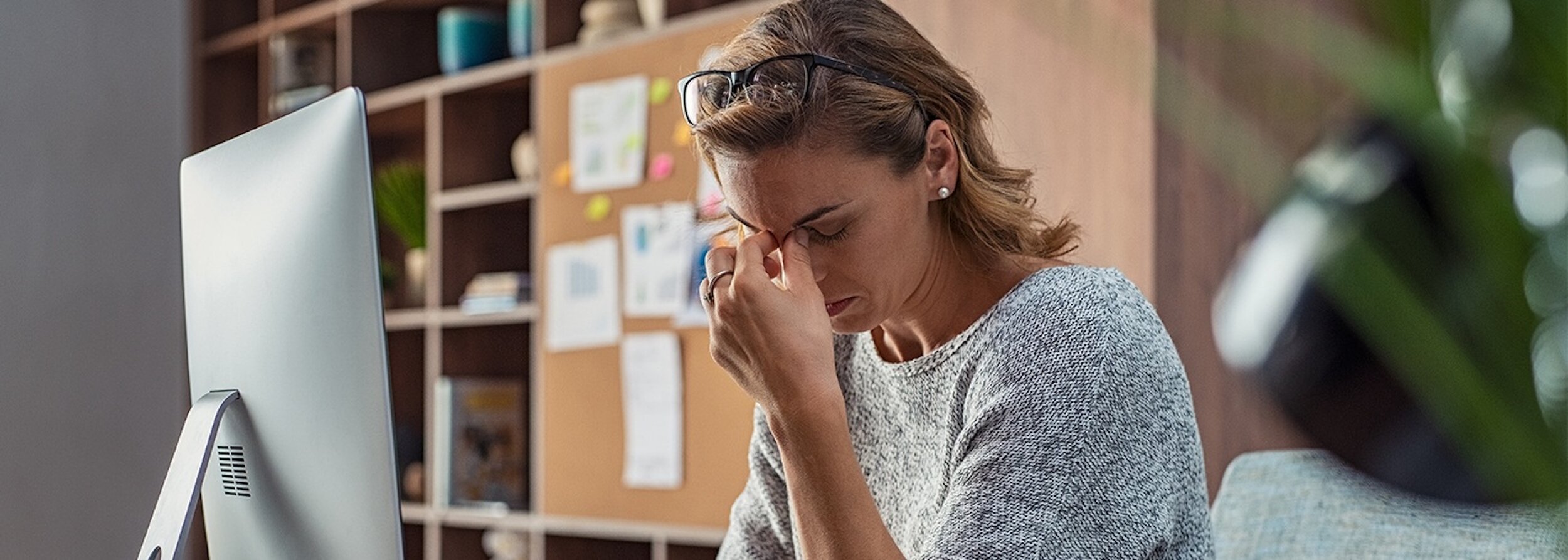 woman pinching the bridge of her nose with her eyes closed